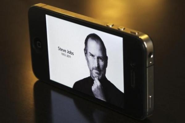 The main Apple Inc website featuring Apple co-founder Steve Jobs is seen on an iPhone in this photo illustration taken in Central Sydney